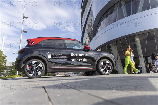 A new Smart brand vehicle in front of the Mercedes Museum in Stuttgart