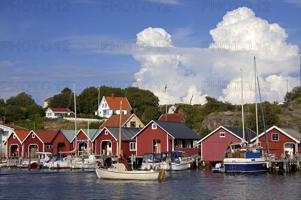 Red wooden boat huts in the harbour at Hamburgsund