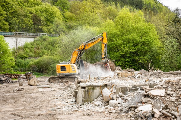 Yellow Liebherr crawler excavator recycling on demolition site