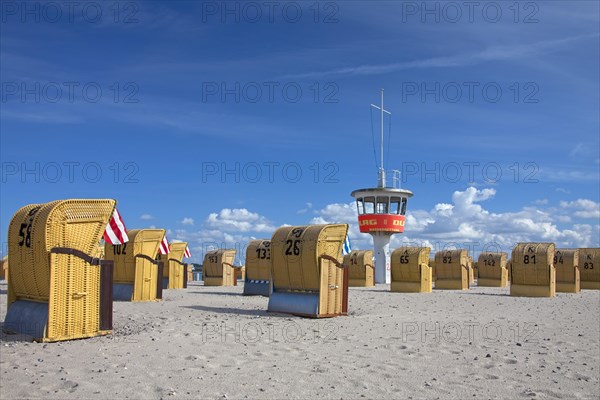 Lifeguard tower and roofed wicker beach chairs on the beach at Travemuende