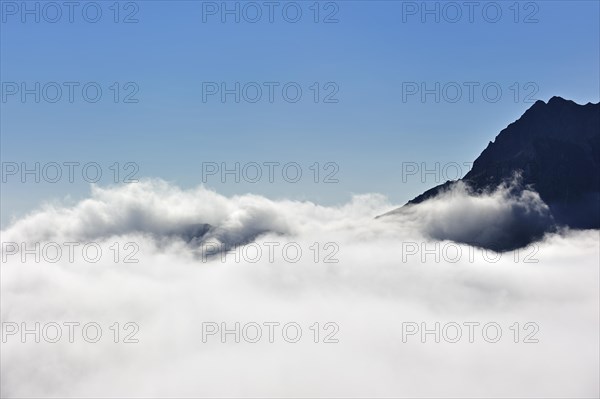 Mountain top towering above rising clouds in the Pyrenees