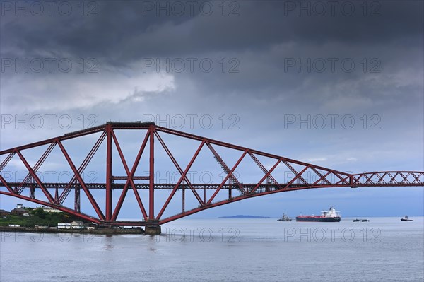 Oil tanker sailing under the Forth Railway Bridge