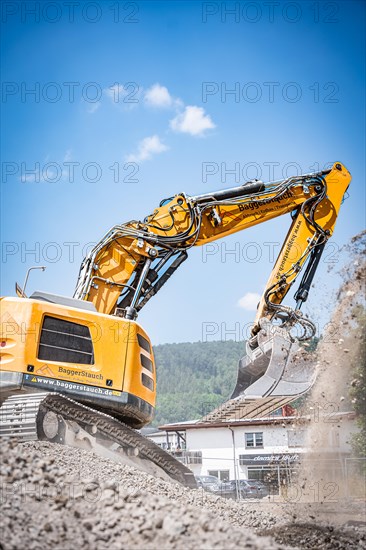 Yellow Liebherr crawler excavator recycling on demolition site