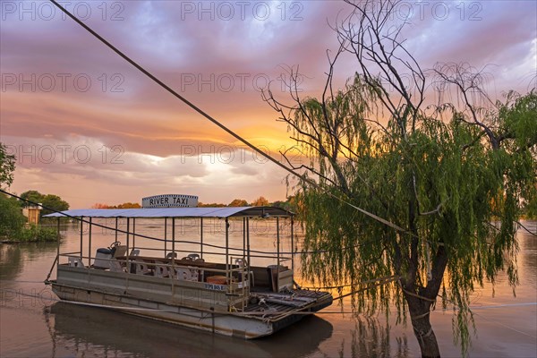 River taxi boat on the Orange river at sunset near Upington
