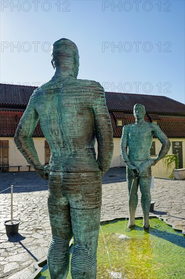 Two male figures peeing