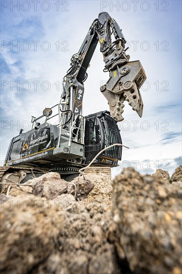 Black Liebherr crawler excavator recycling on demolition site