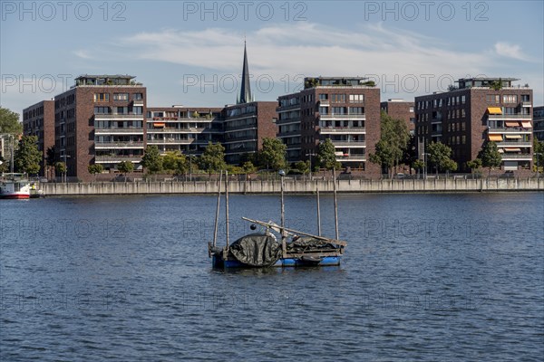 Illegally anchored houseboats in the Rummelsburg Bay with the residential houses on the Rummelsburg shore