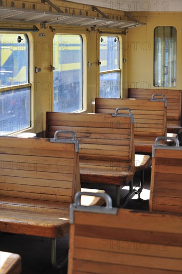 Old passenger carriage with wooden benches at the depot of the Chemin de Fer a Vapeur des Trois Vallees at Mariembourg