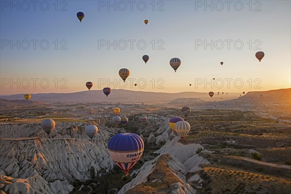 Hot air balloons flying over Cappadocia at sunrise