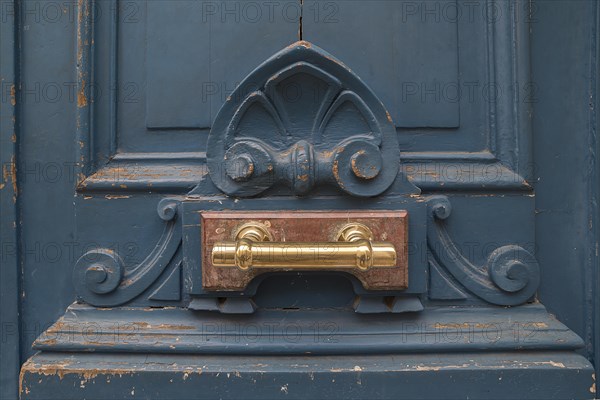 Brass door handle on an old front door