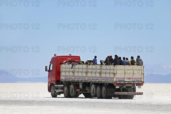 Truck with school children on the salt flat Salar de Uyuni