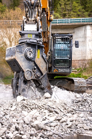 Yellow Liebherr crawler excavator recycling on demolition site