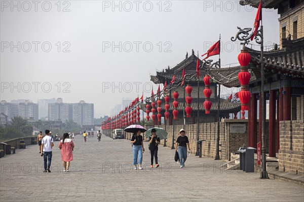 Chinese tourists and red lanterns along the city walls