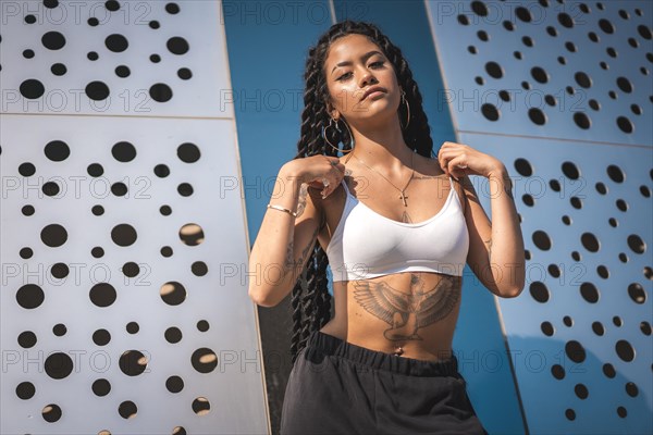 Young black woman with long braids and with tattoos