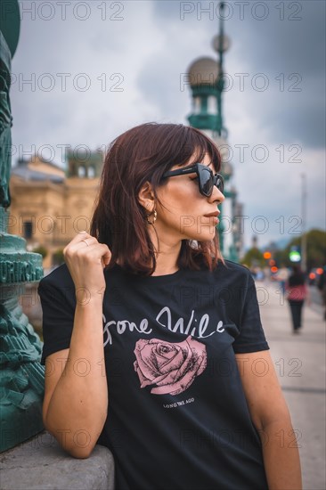 Lifestyle in the city. A young brunette with sunglasses