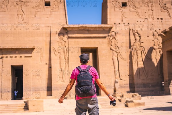 A young man in a pink shirt at the Temple of Philae