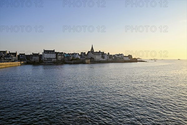 Old town with buildings and church tower by the sea