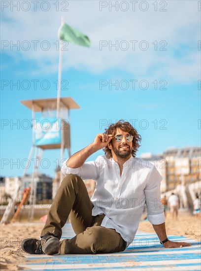 Summer lifestyle with a young dark-haired Caucasian man with long beard
