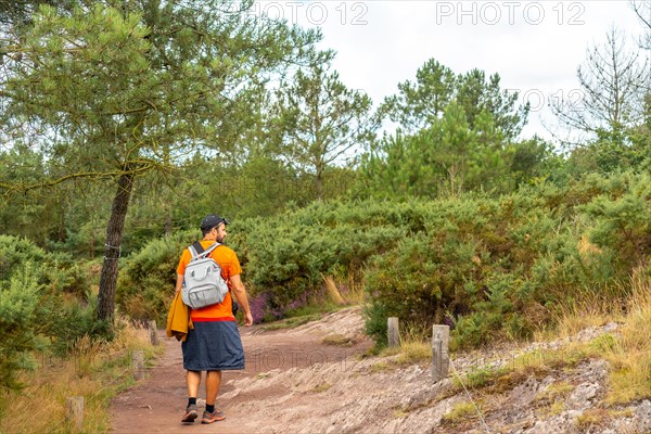 A young man on the footpath in the Broceliande forest