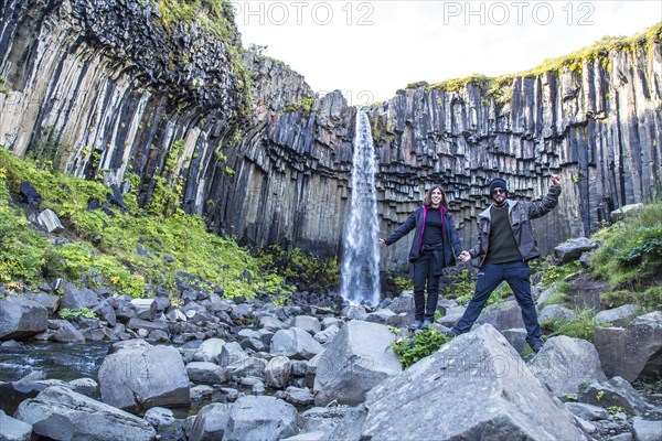 A couple in Svartifoss waterfall