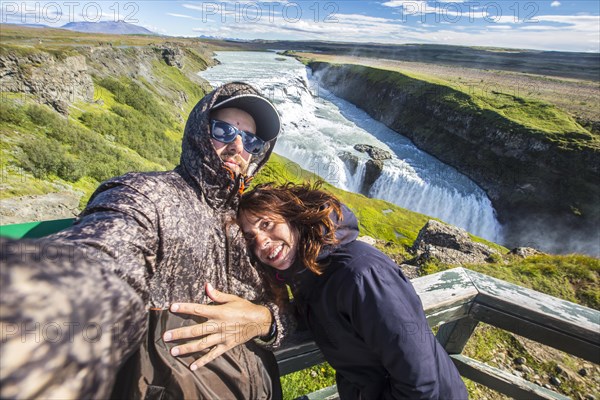 A couple above the Gullfoss waterfall in the golden circle of the south of Iceland