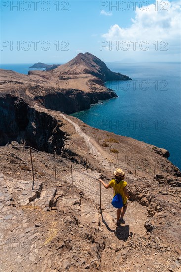 A young woman in Sao Lourenco going down the stairs of the trekking trail