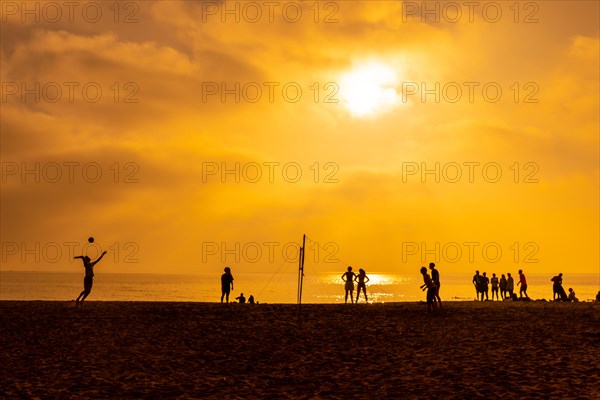 Some young people playing volleyball on the beach of San Miguel in the city of Almeria