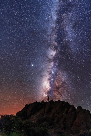 A young woman below the beautiful lactea way of the Caldera de Taburiente near the Roque de los Muchahos on the island of La Palma