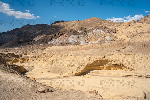 A dry river on the Artist's Drive crossing and in the background Artist Point in Death Valley