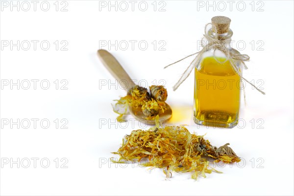 Wooden spoon with dried calendula flowers