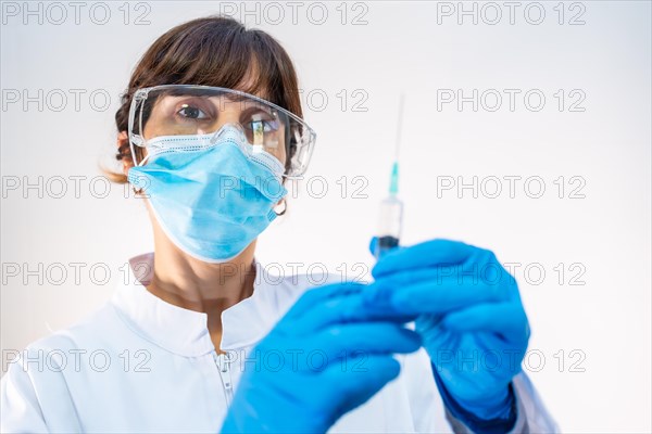 Female doctor preparing the injection of the coronavirus vaccine. Antibodies