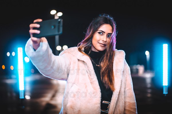 Caucasian brunette taking a selfie on the phone