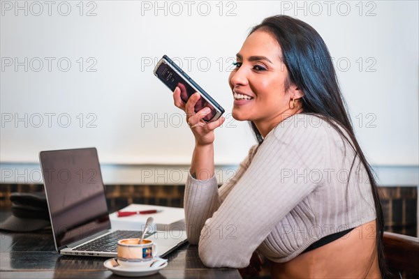 Brunette girl teleworking in a cafeteria with her laptop