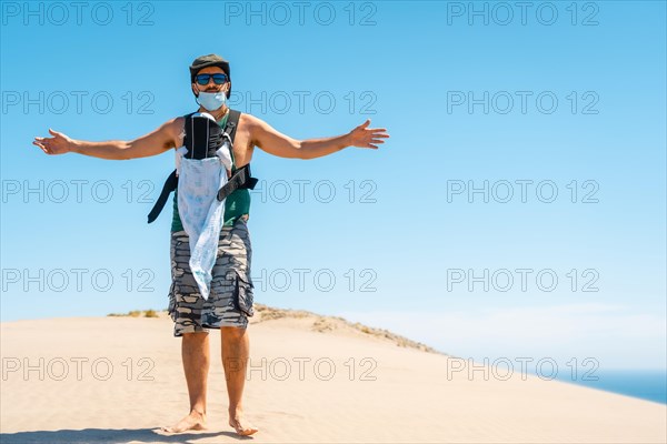 A young man enjoying the holidays with his son on the sand dune at Monsul beach in the Cabo de Gata Natural Park