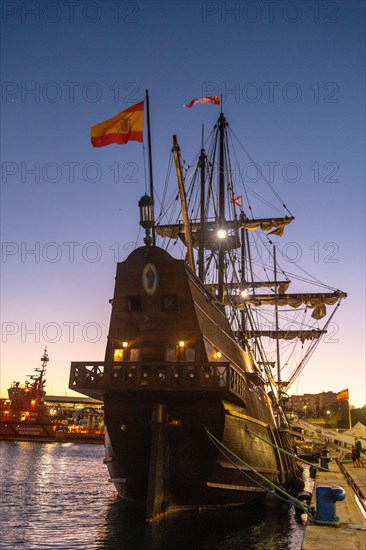 Old boat at sunset on the promenade of Muelle Uno in the Malagaport of the city of Malaga