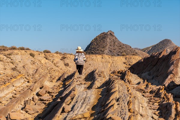 A young hiker girl in Colas de Dragon in the desert of Tabernas