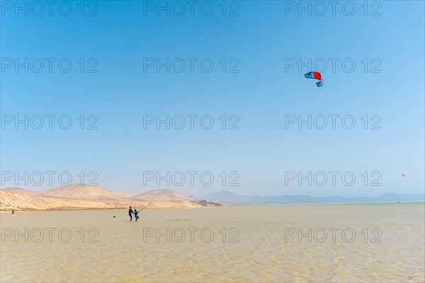 Children learning Kitesurfing or sky surfing on Sotavento beach in the south of Fuerteventura