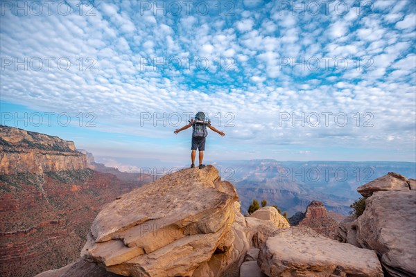 A young man on a viewpoint of the descent of the South Kaibab Trailhead. Grand Canyon