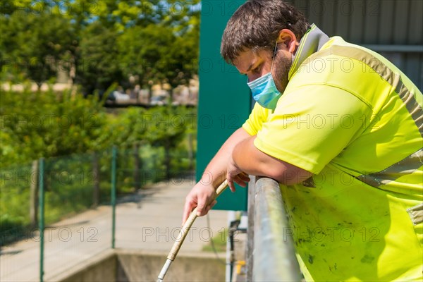 Worker in a recycling factory or clean point and garbage with a face mask and with security protections