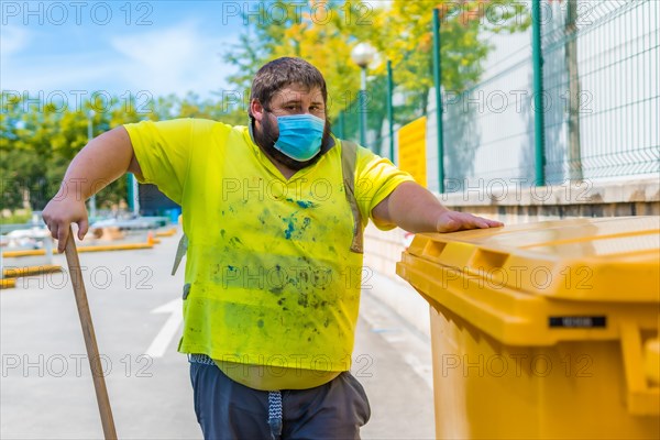 Worker in a recycling factory or clean point and garbage with a face mask and with security protections