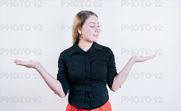 Smiling woman comparing with palms with hands isolated. Girl balancing something with palms isolated