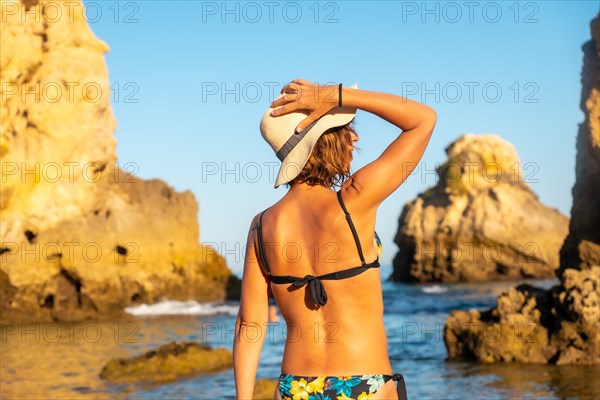 A woman on vacation at Praia dos Arrifes