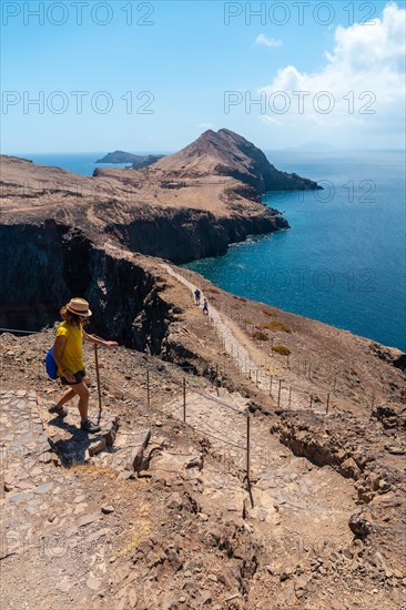 A young woman in Sao Lourenco going down the stairs of the trekking trail