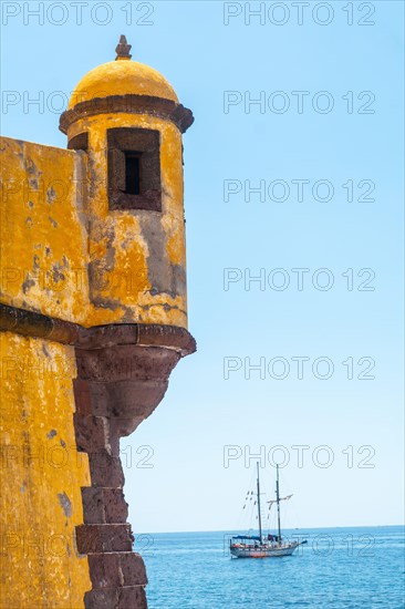 Yellow watchtower at the Forte de Sao Tiago on the beach of Funchal. Madeira