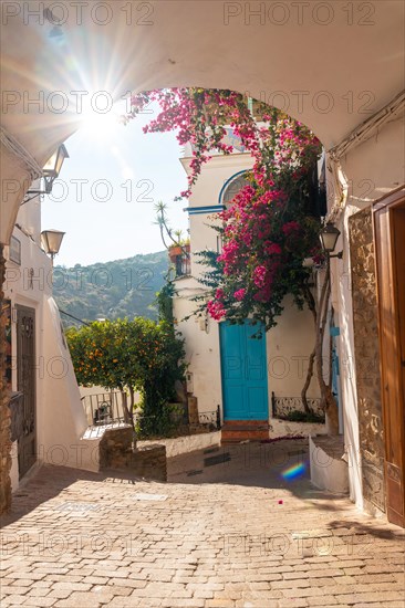 The city gate of Mojacar with white houses on top of the mountain. Costa Blanca in the Mediterranean Sea