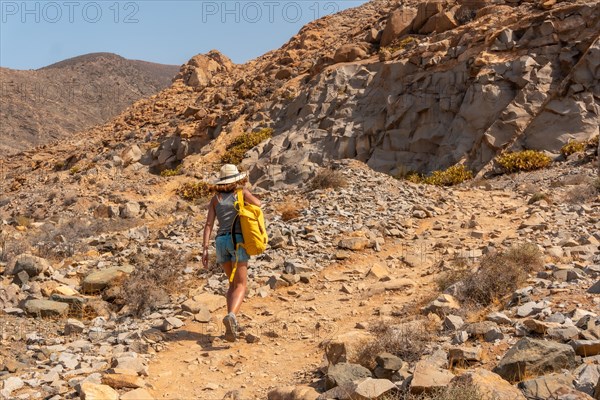 A young woman walking along the canyon path towards the Mirador de la Penitas