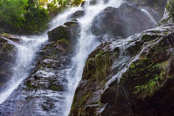 Stunning waterfal through the rocks and forest in Minas Gerais
