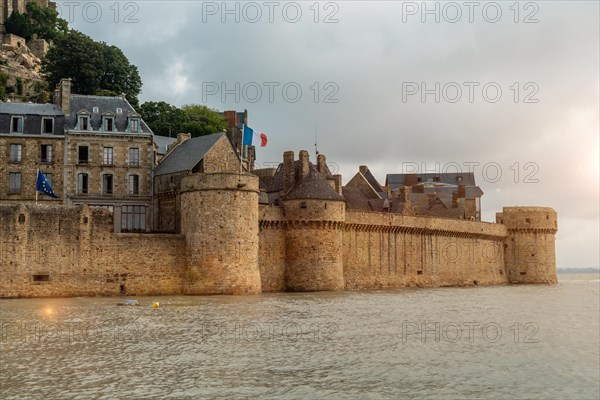 The famous Mont Saint-Michel Abbey at sunrise at high tide in the Manche department