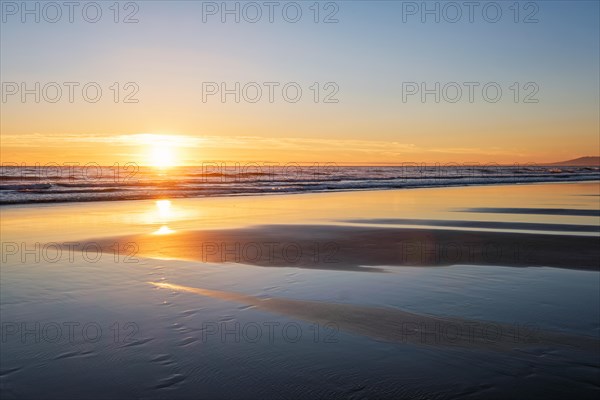 Atlantic ocean sunset with surging waves at Fonte da Telha beach