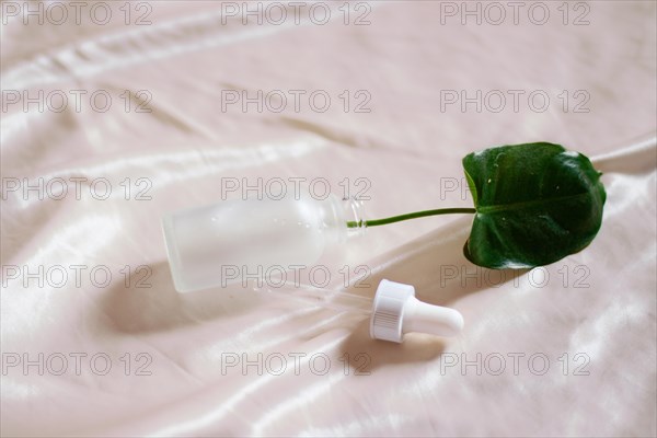 A green leaf in a glass dropper bottle